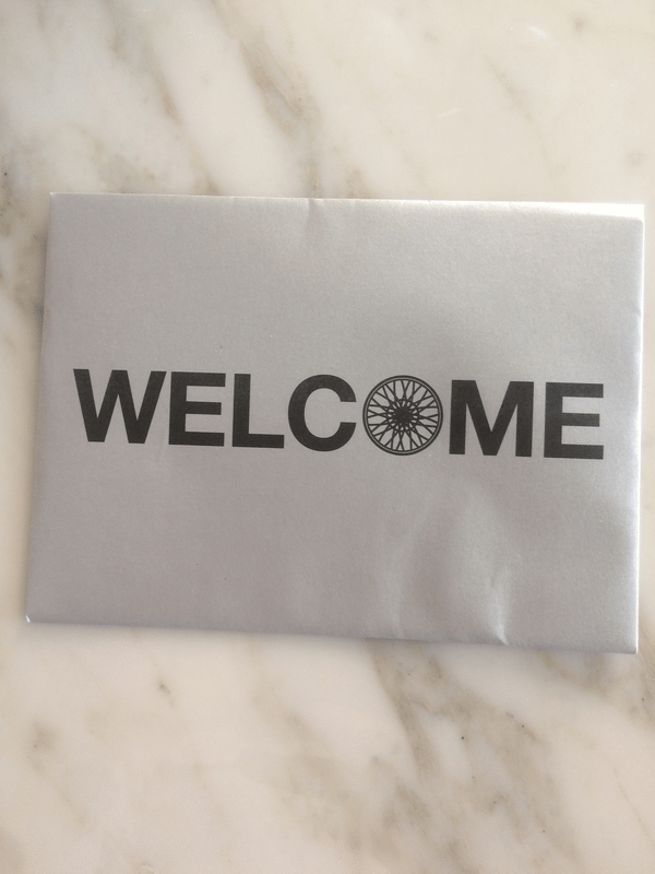 Welcome envelope with a card inside that invites people to come back for a free class